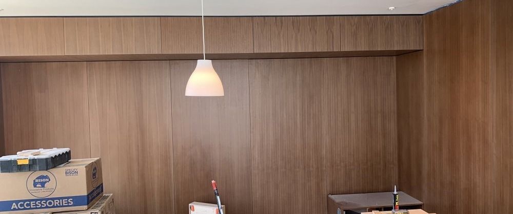 Santa Monica remodel — primary bedroom with walnut paneling being installed, under construction