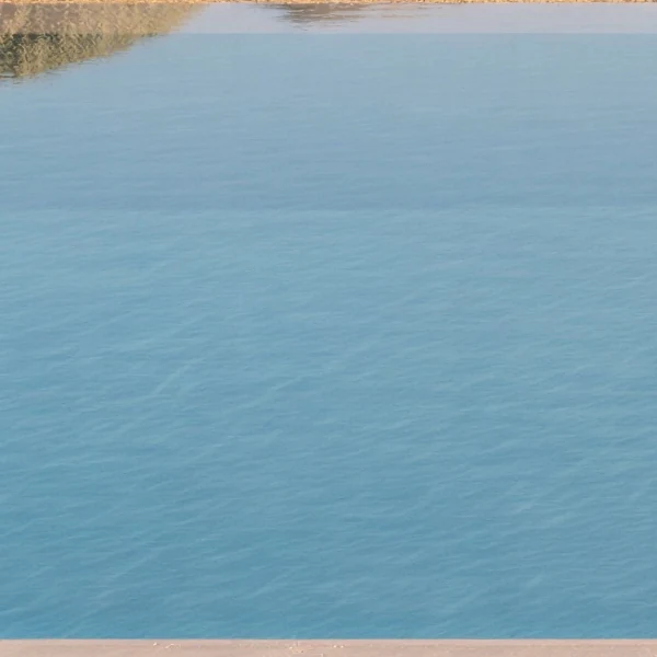 Pool water over pale sandy plaster, swatch cut from a rendering.