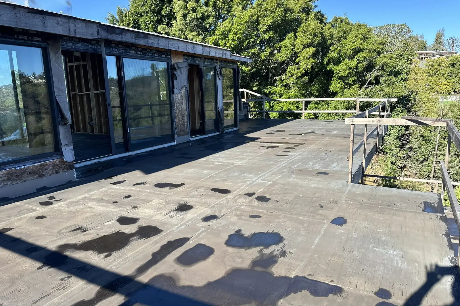 Glass walls and an unfinished roof deck on an Akopi Builders custom home under construction in Bel Air.