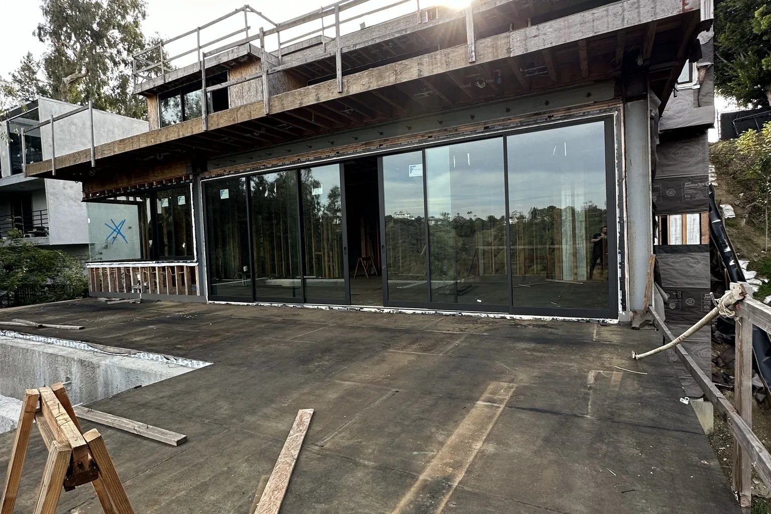 A glass-walled lower level and the deck above it during construction of an Akopi Builders home in Bel Air.