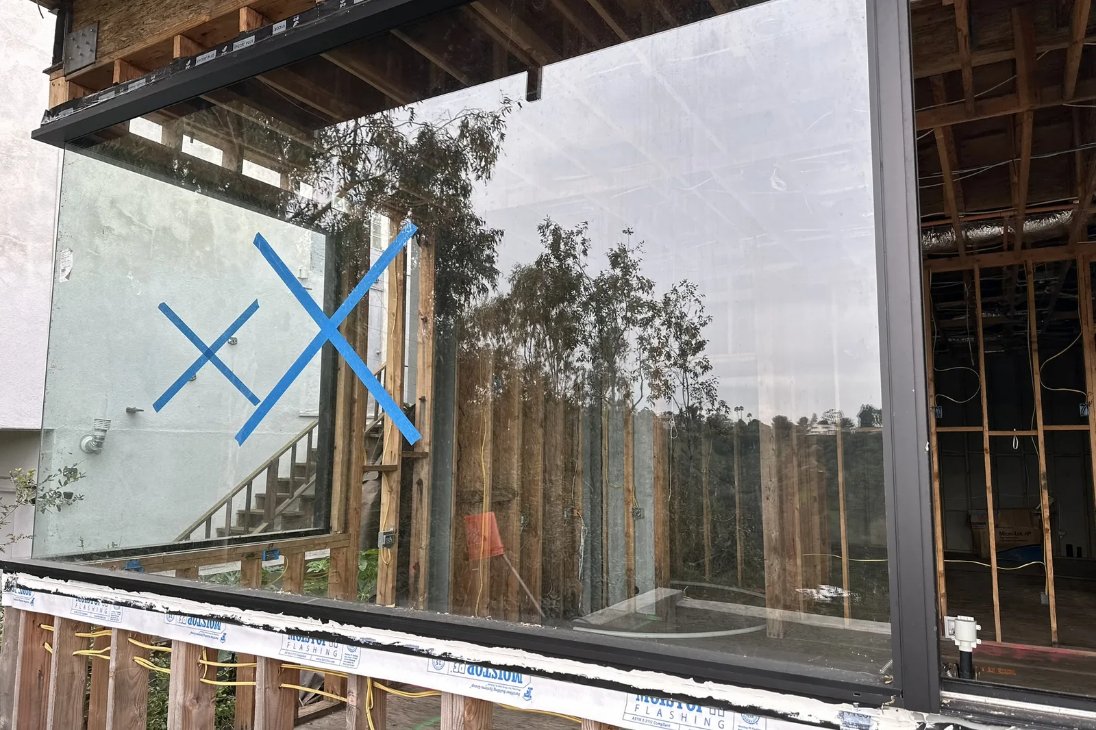 A large window panel just set and taped on an Akopi Builders custom home under construction in Bel Air.