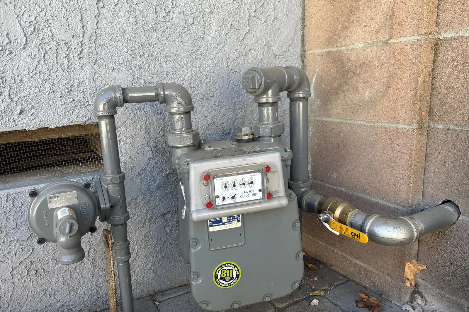Gas meter and new gas piping on a stucco wall at Arnwood, an Akopi Builders backyard build in Los Angeles.