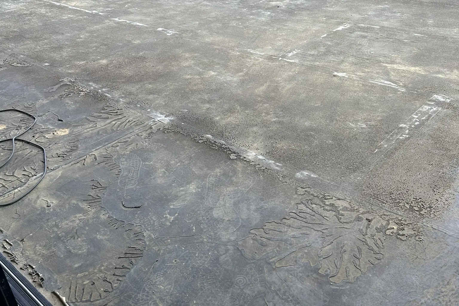 A freshly poured concrete slab on a hillside lot above a wooded canyon, on an Akopi Builders custom home in Bel Air.