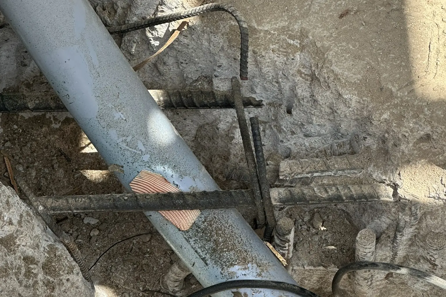 Rebar and a drain pipe at a concrete footing during foundation work on an Akopi Builders home in Bel Air.